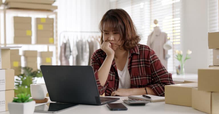 7 Most Costly Accounting Mistakes Small Business Make. Photo of stressed woman business owner on laptop